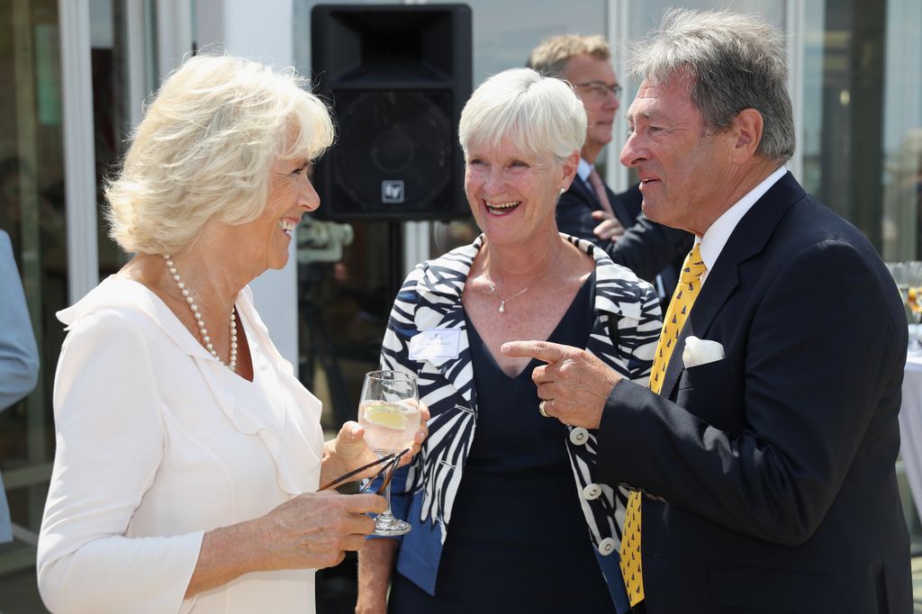 Alan Titchmarsh and his wife Alison Titchmarsh chat to Queen Camilla, then the Duchess of Cornwall at the Royal Yacht Squadron on July 24, 2018