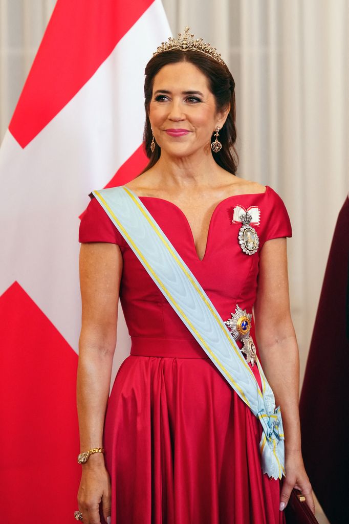 Queen Mary wearing red dress and tiara