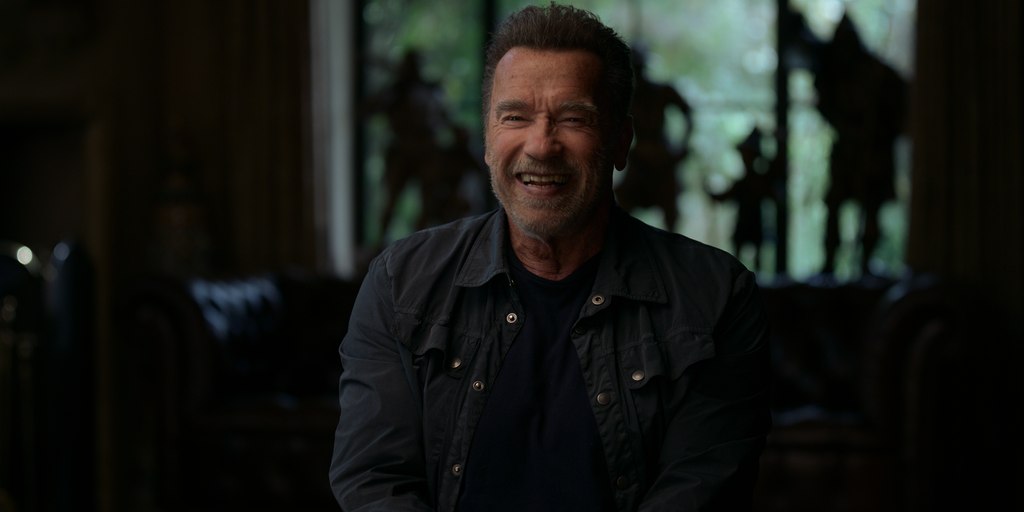 Arnold Schwarzanegger laughs in Netflix documentary
