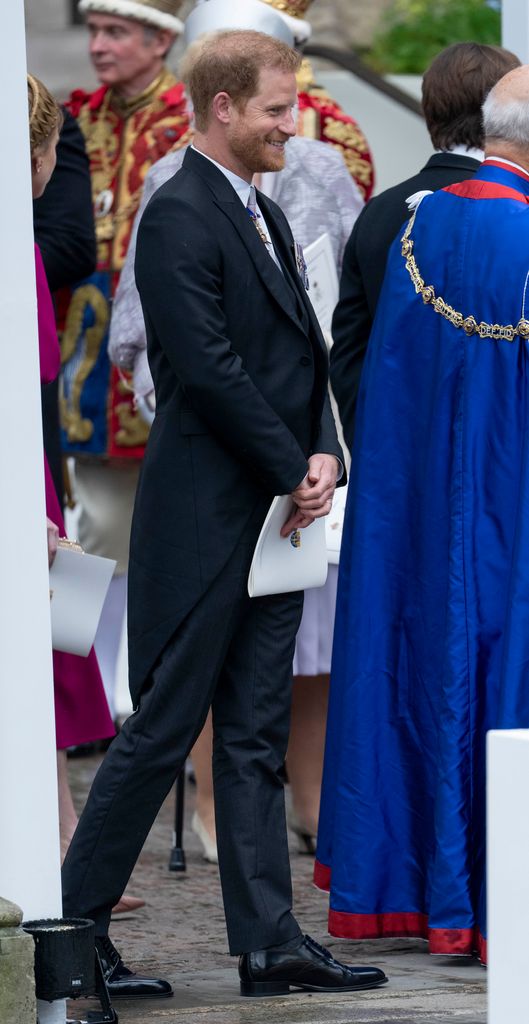 Prince Harry was pictured taking an Order of Service with him