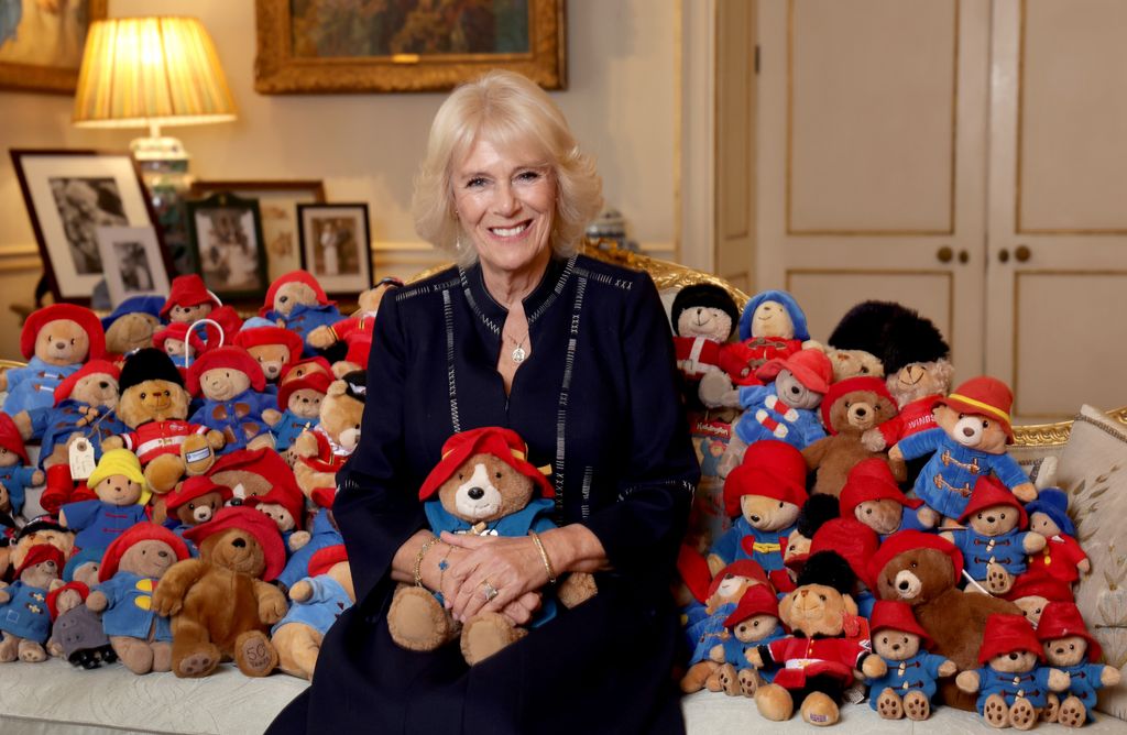 Camilla poses with a collection of Paddington cuddly toys in the Morning Room at Clarence House, on the 64th anniversary of the publication of the first Paddington bear book in 2022