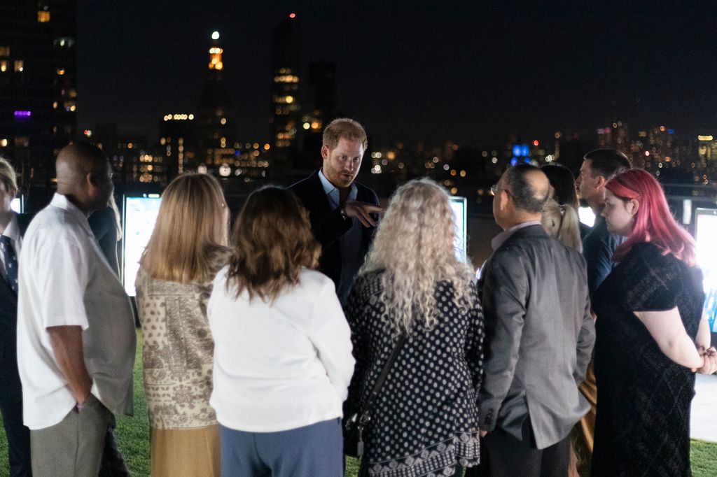 Prince Harry speaking to parents in front of Archewell Vigil
