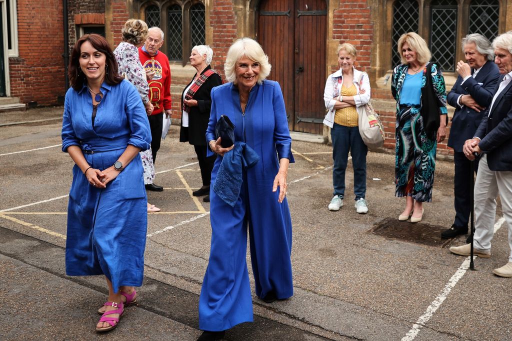 Queen Camilla wearing an bold blue wide-leg jumpsuit