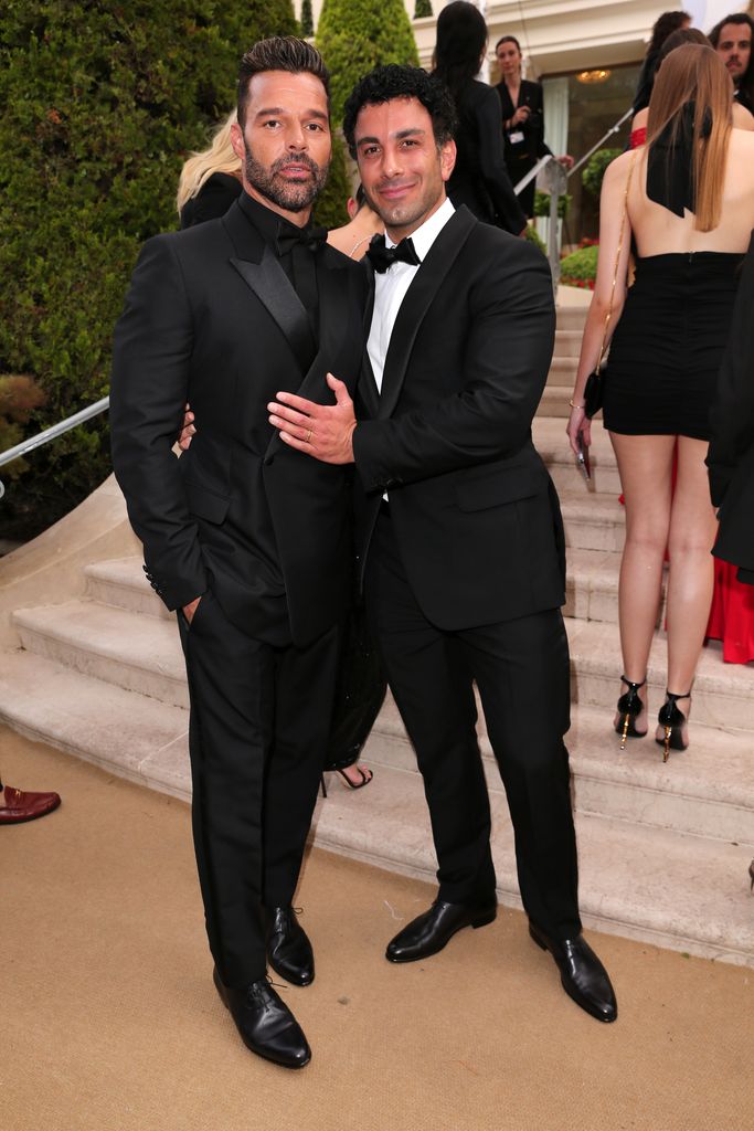 Ricky Martin hugging Jwan Yosef in matching black suits
