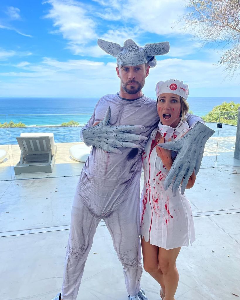 Chris Hemsworth and Elsa Pataky in Halloween costumes with their pool deck behind them