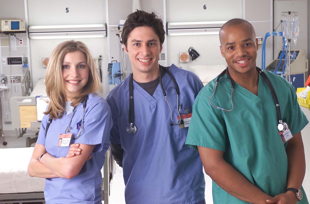 Actors Sarah Chalke, Zach Braff, and Donald Faison poses for a publicity photo for the television show "Scrubs."