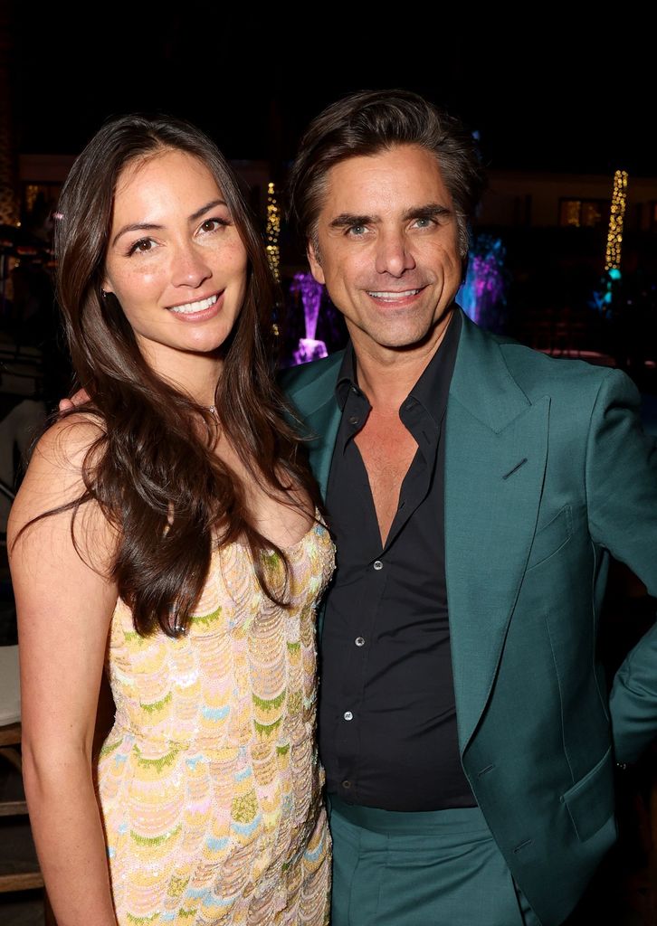 Caitlin McHugh and John Stamos attend the World Premiere of Disney's live-action feature "The Little Mermaid" at the Dolby Theatre in Los Angeles, California on May 08, 2023