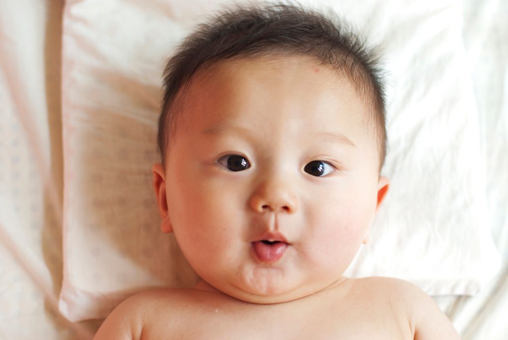 baby with cute expression and fluffy hair