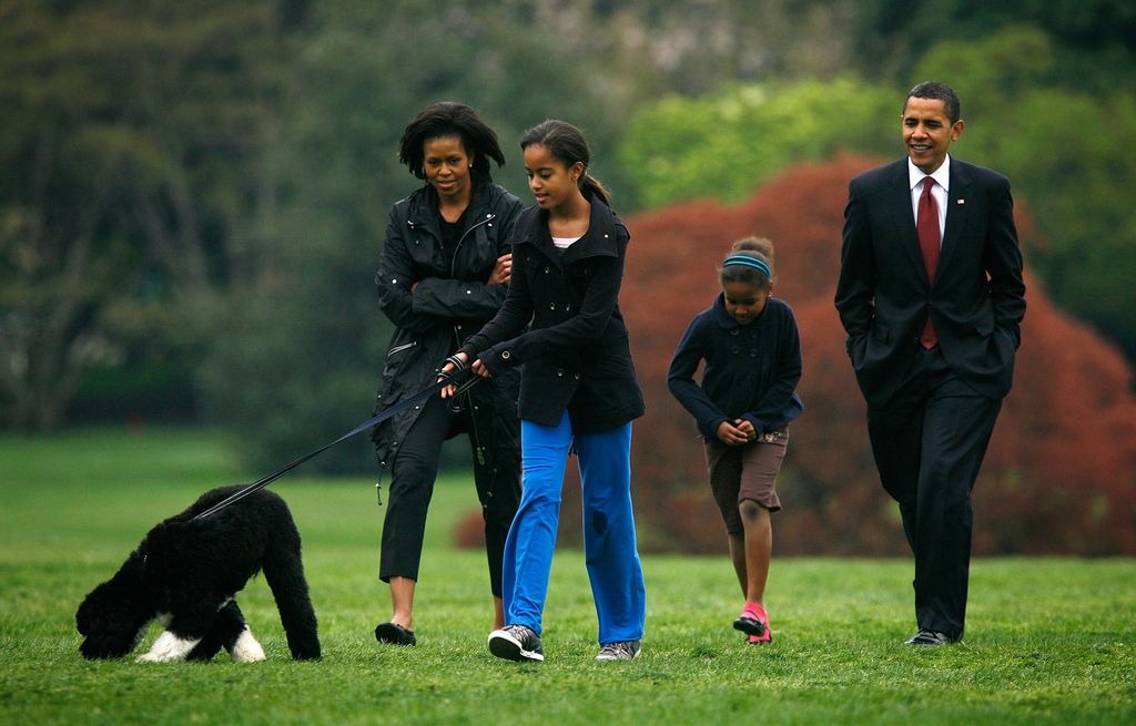U.S. President Barack Obama (R), first lady Michelle (L) and their daughters, Malia (2nd L) and Sasha (3rd L) introduce their new dog, a Portuguese water dog named Bo, to the White House press corps at the South Lawn of the White House April 14, 2009 in Washington, DC. The six-month-old puppy is a gift from Sen. Edward M. Kennedy (D-MA) who owns several Portuguese water dogs himself. This breed of dog is considered a good pet for children who have allergies, as Malia does.