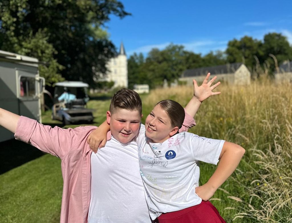 brother and sister celebrating outside in garden