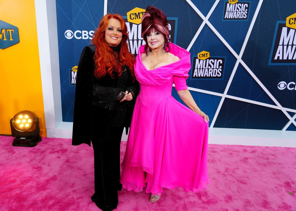 Wynonna Judd and Naomi Judd on the pink carpet together smiling