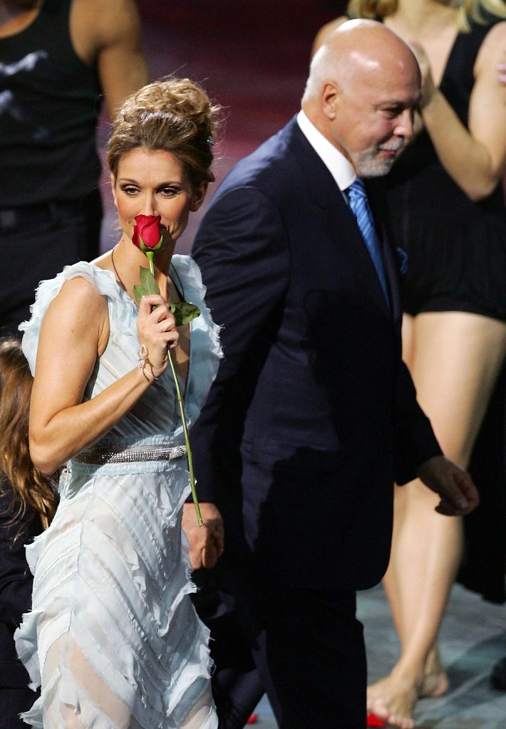 Singer Celine Dion (L) is escorted by her husband and manager Rene Angelil as she leaves the stage after the last performance of her show "A New Day..." at The Colosseum at Caesars Palace December 15, 2007 in Las Vegas, Nevada. Nearly three million people watched Dion perform 717 shows since it opened in March 2003.  (Photo by Ethan Miller/Getty Images for AEG Live/Concerts West)