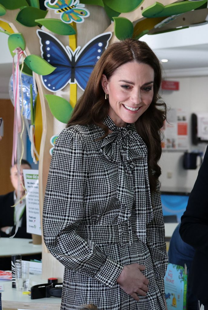 Catherine, Princess of Wales smiling in grey check dress