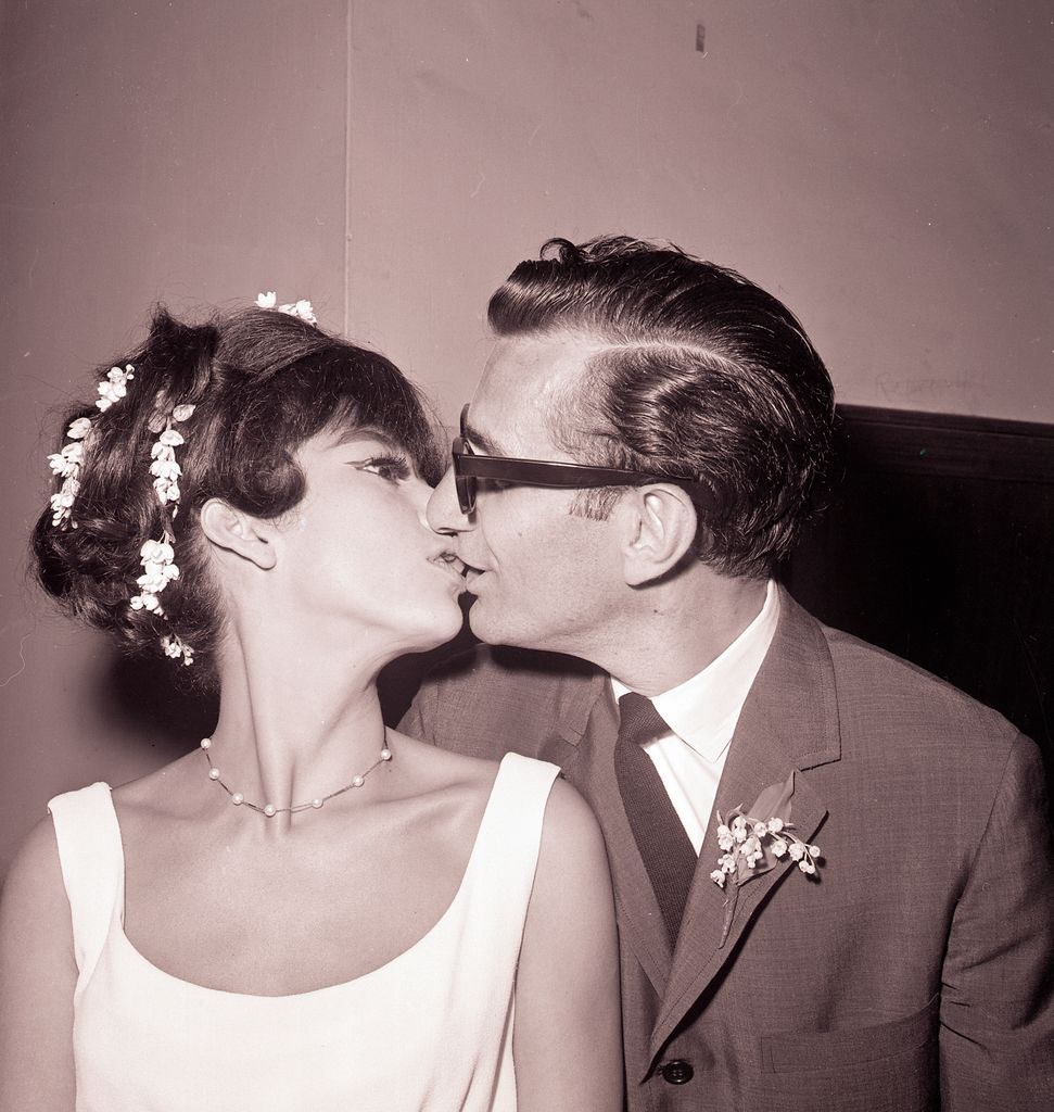 Rita Moreno, 33, who won an "Oscar" for her role in the film musical "West Side Story," kisses her new husband Dr. Leonard Gordon, 45, after their marriage; 6/18/1965-New York, New York