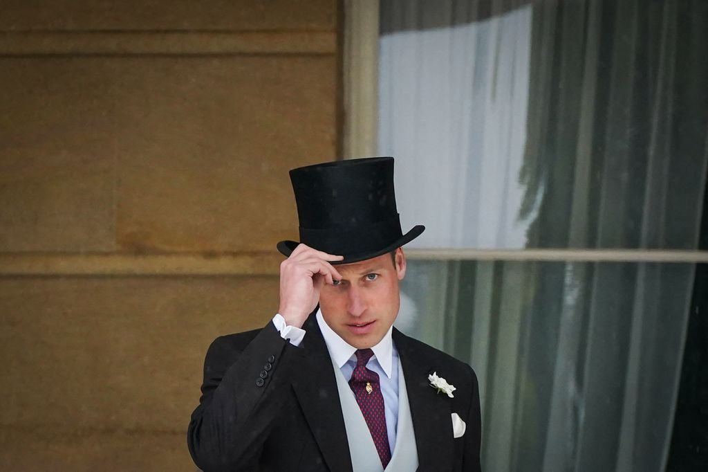 Britain's Prince William, Prince of Wales posing in top hat and tails at Buckingham Palace Garden Party