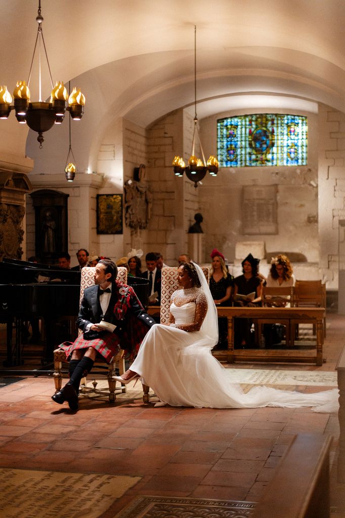 Mel B and her husband Rory sitting during their wedding ceremony