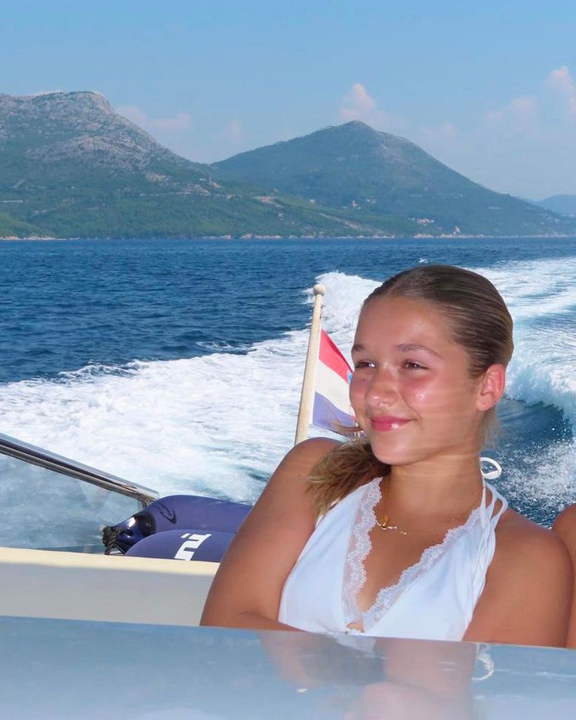 Harper Beckham in a white top on a boat