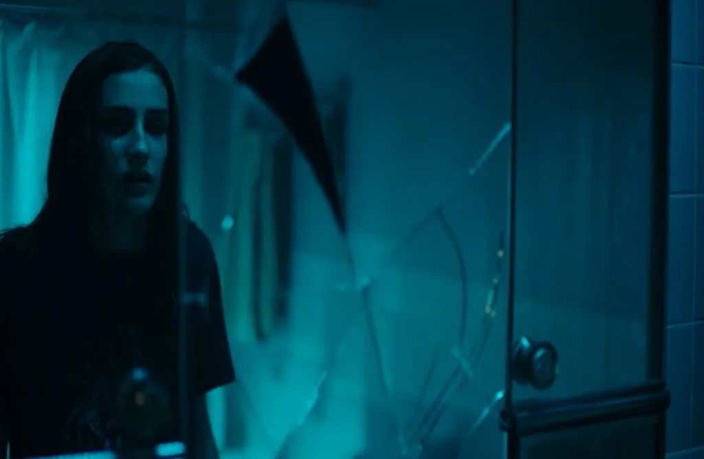 Veronica looking at a smashed mirror in the film Veronica