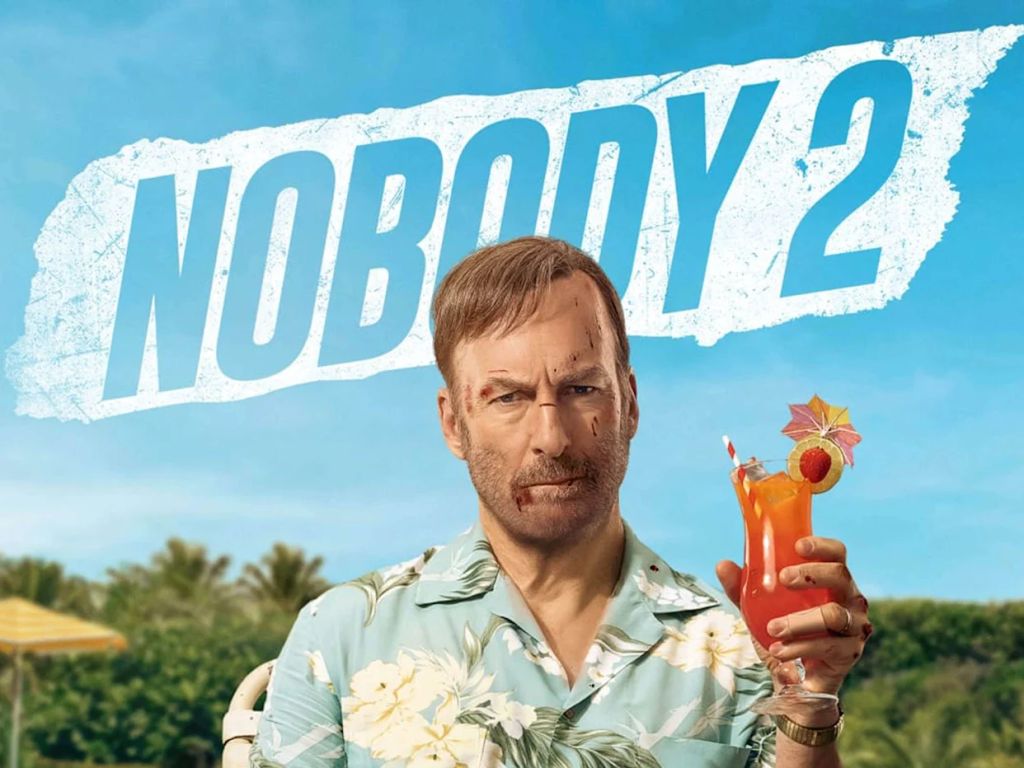 A bloody Bob Odenkirk holds a cocktail on the poster for Nobody 2
