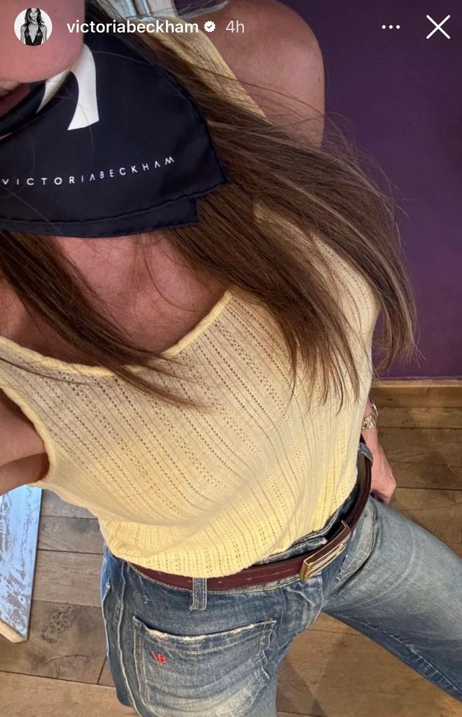 Victoria Beckham wearing her new denim jeans and a yellow vest top