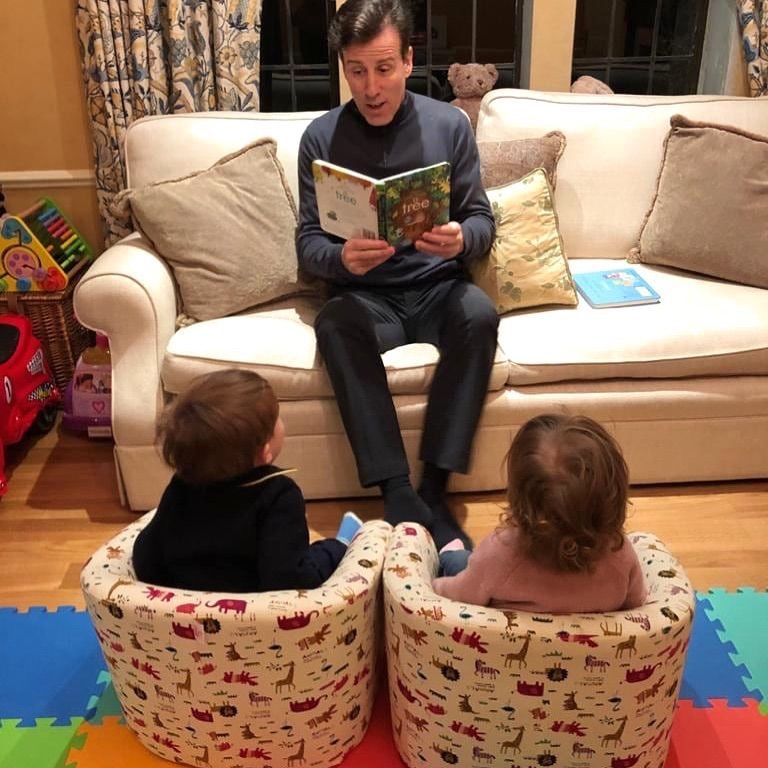 anton reading book to twin children
