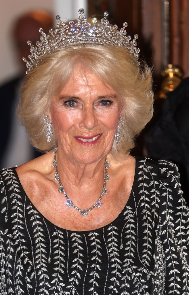Queen Camilla arrives at a reception and dinner in honour of their Coronation, wearing a tiara and diamond jewellery