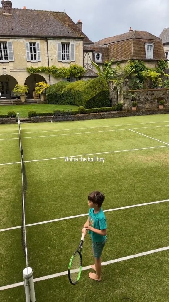 Wolfie Mapelli Mozzi holding a tennis racket 