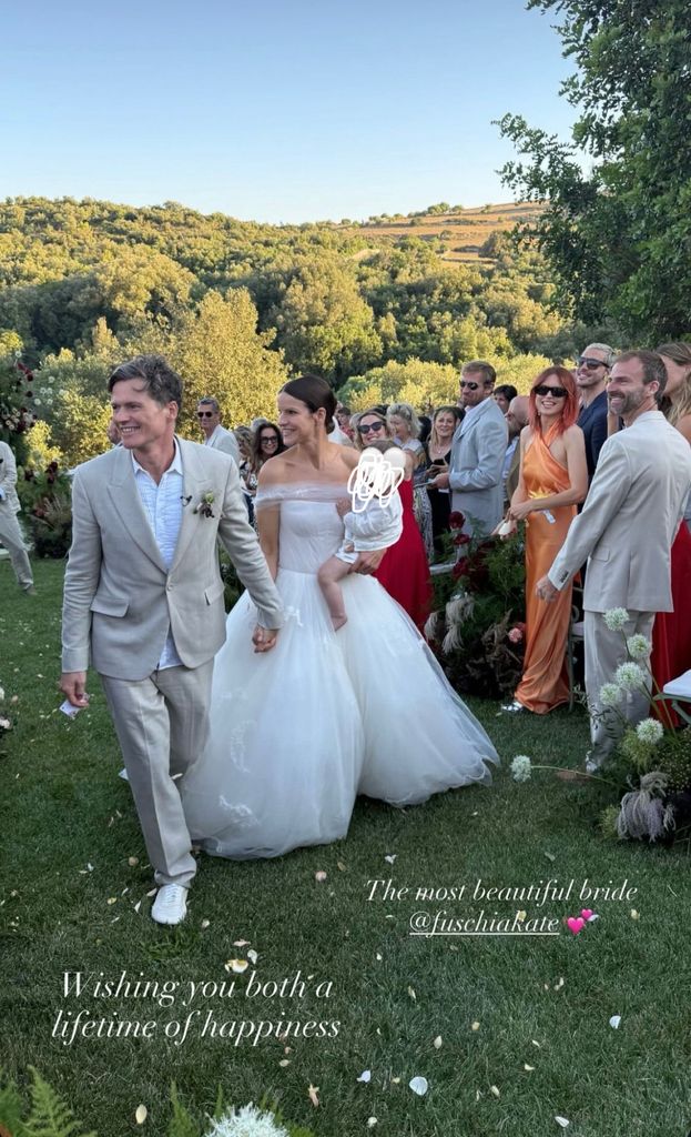 married couple walking down aisle outside