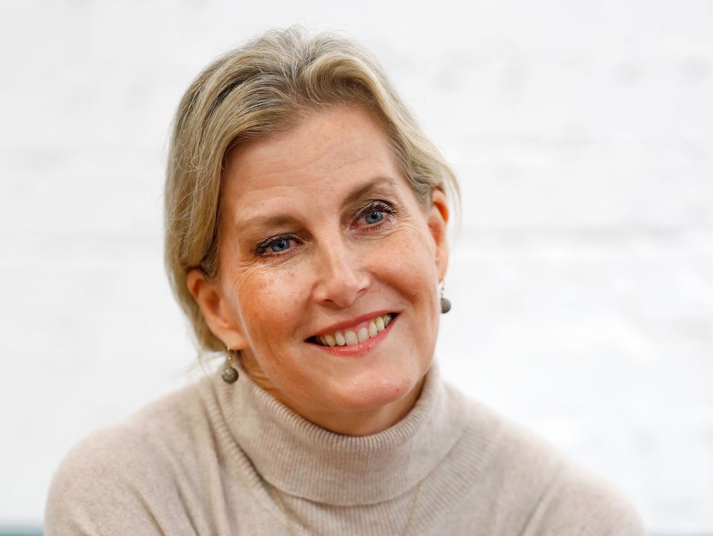 Sophie, Duchess of Edinburgh smiling up close in rollneck oatmeal dress