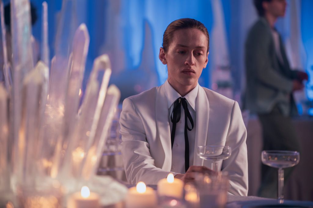 man dressed in white sitting at table