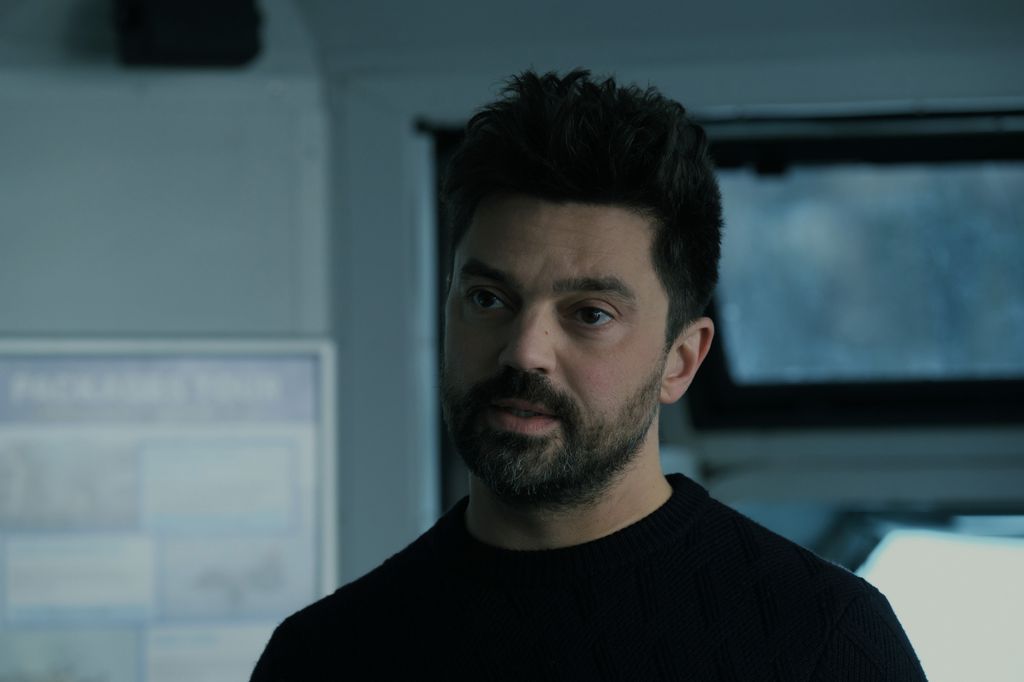 A man stands in a black t-shirt