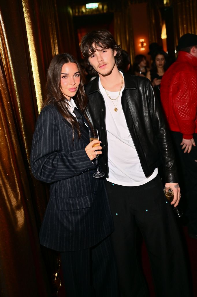 couple posing for photos at after party london 