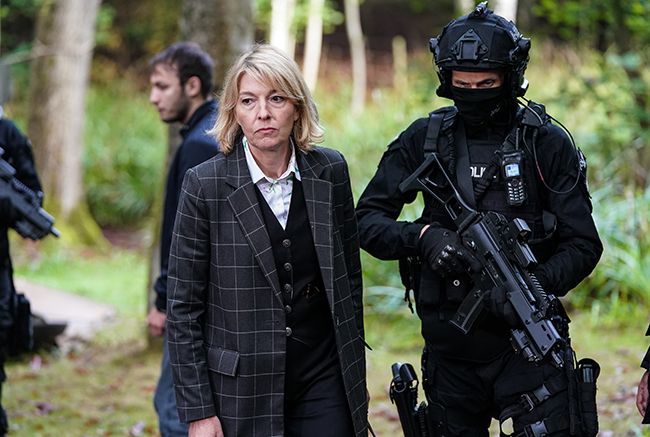 Jemma Redgrave stands next to armed officer in Silent Witness