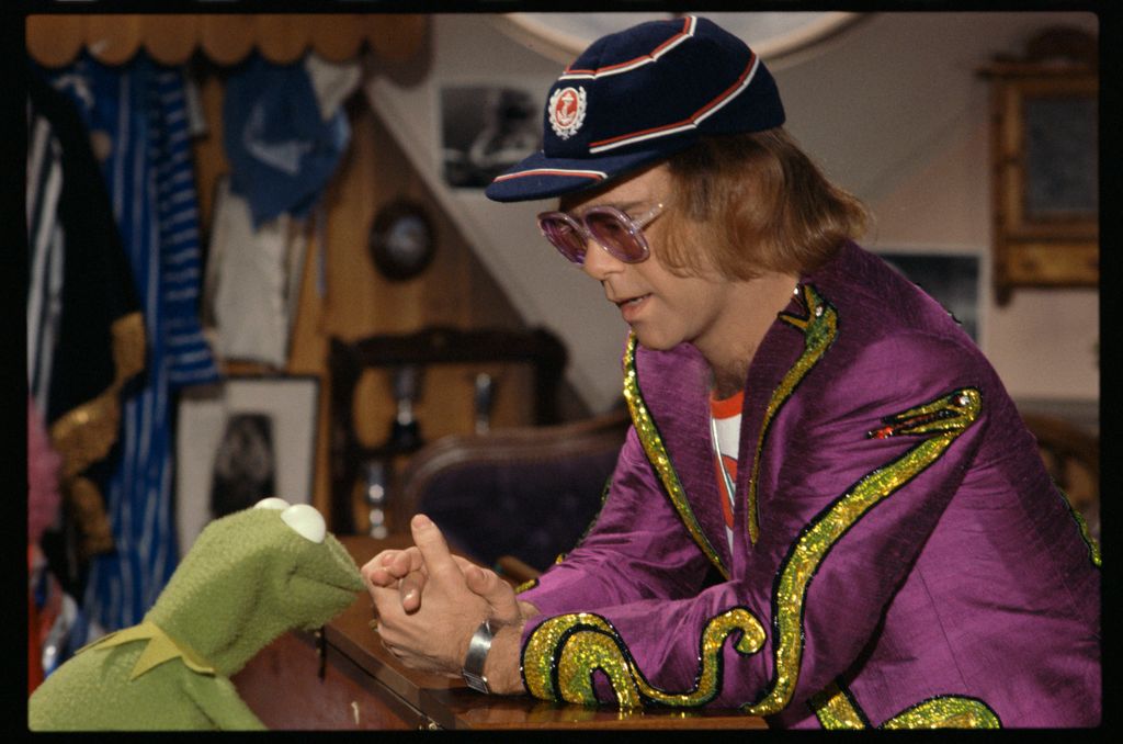 Elton John with puppet character Kermit The Frog on the set of The Muppet Show at Elstree Studios, Hertfordshire, circa October 1977