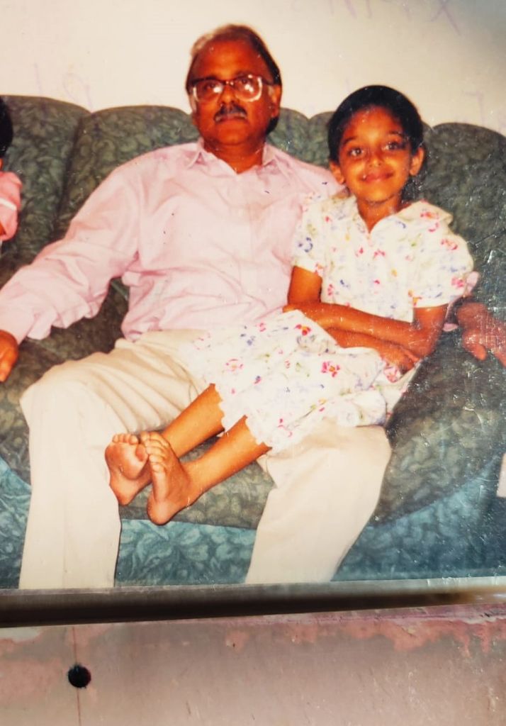 Young girl on her grandfather's lap