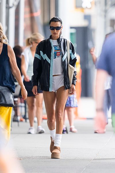 Bella Hadid cuts a stylish figure in motorcycle jacket with sweats and a Louis  Vuitton carry-on bag