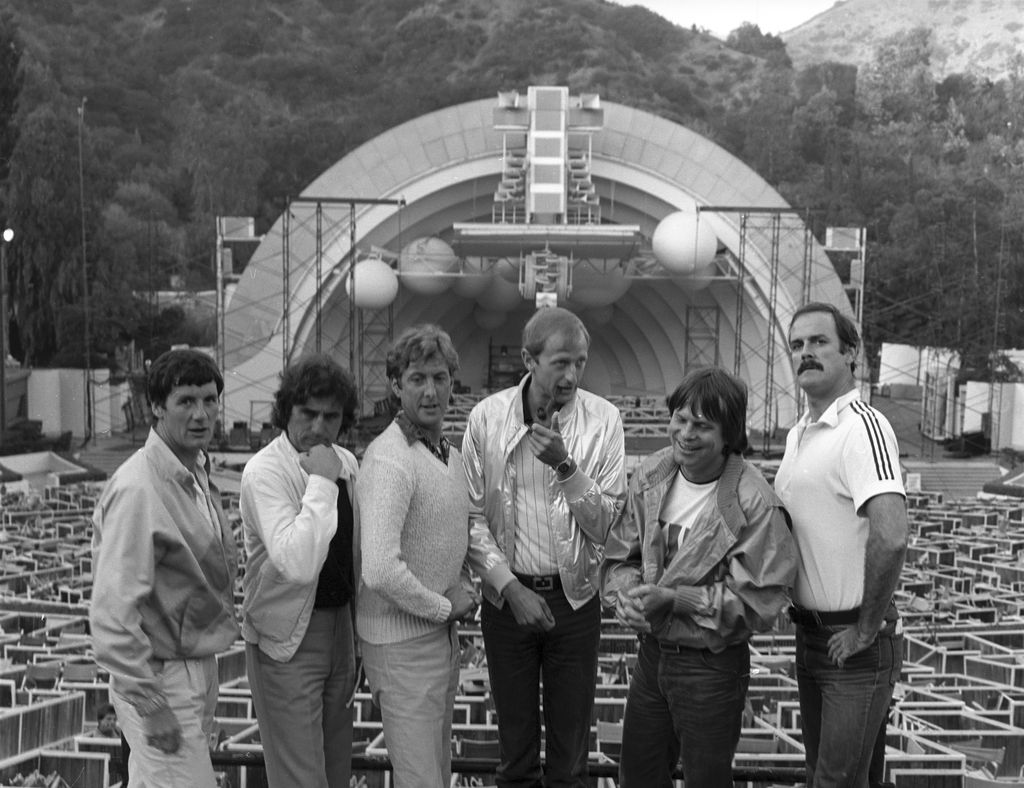 Monty Python including (left to right) Michael Palin, Terry Jones (1942-2020), Eric Idle, Graham Chapman (1941 - 1989), Terry Gilliam, and John Cleese, clown about prior to their filmed live show at the Hollywood Bowl