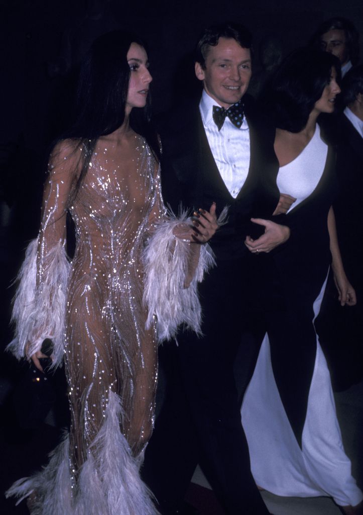 Singer Cher, fashion designer Bob Mackie and Cher's friend Paulette Betts attend The Metropolitan Museum of Art's Costume Insitute Gala Exhibition "Romantic and Glamorous Hollywood Design" on November 20, 1974 at The Metropolitan Museum of Art in New York City. (Photo by Ron Galella/Ron Galella Collection via Getty Images)