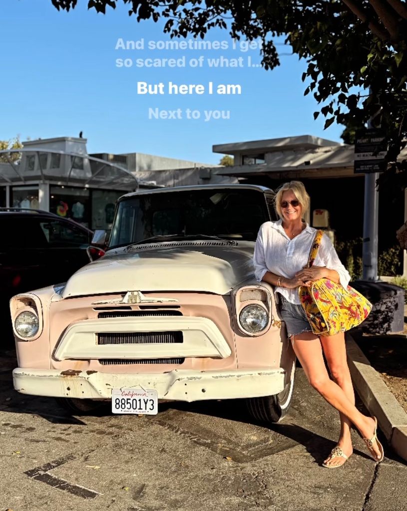 Penny lancaster posed by a vintage car in Malibu