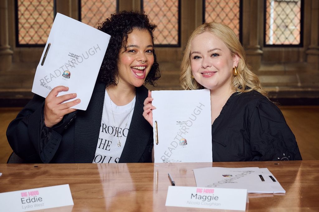two women sitting at table read