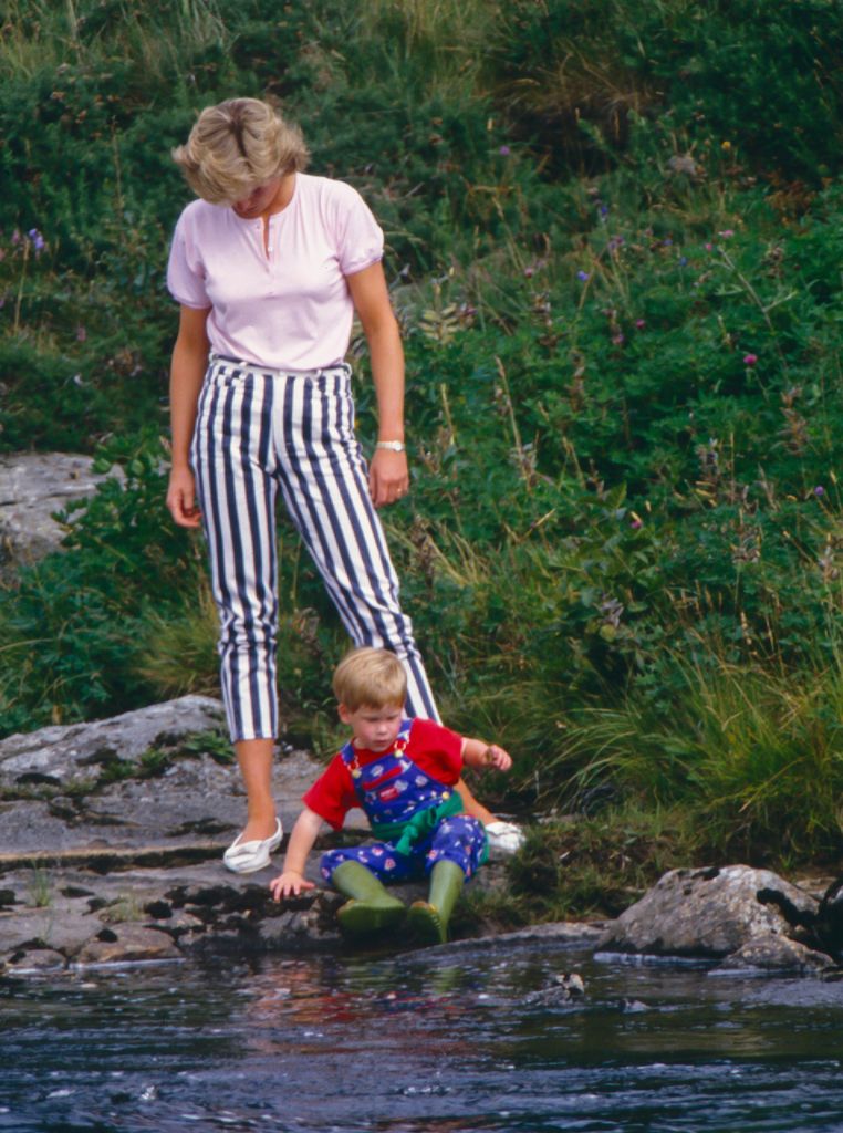 Diana, Princess of Wales, and Prince Harry play on the banks of the River Dee, near Balmoral Castle.