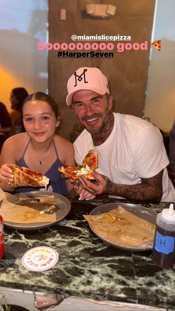 Harper Beckham and David Beckham eating pizza