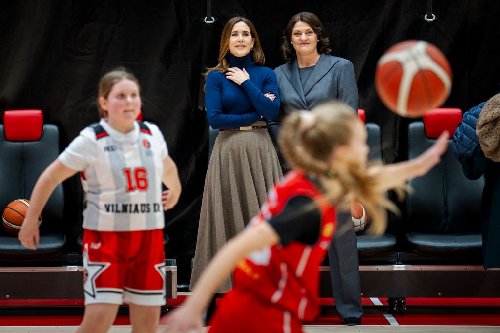 Queen Mary watching young girls play basketball