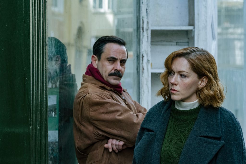 man and woman standing outside building