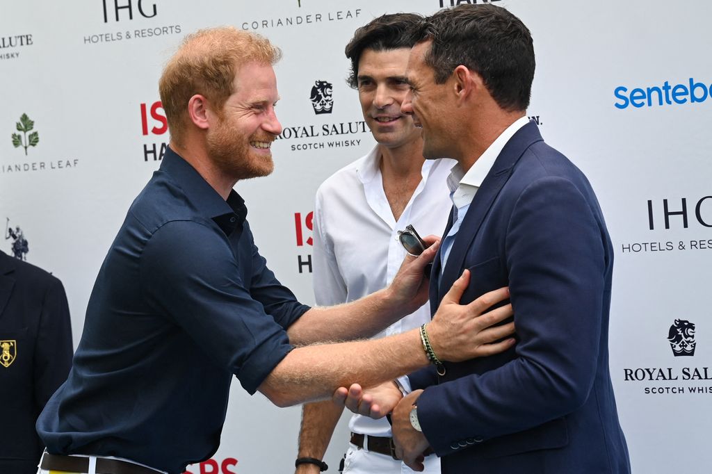 Britain's Prince Harry hugs Dan Carter former All Blacks rugby player and current ISPS Handa ambassador 