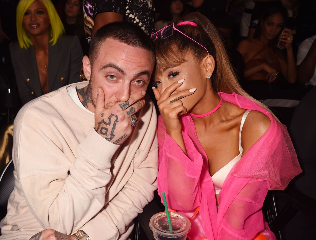 Ariana posing with mac miller on chair 