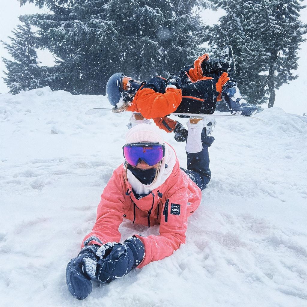 Frankie Bridge and her child snowboarding 