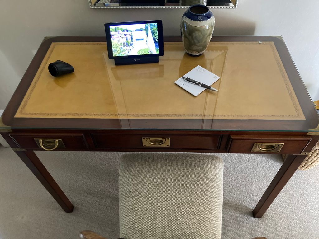 Writing desk with a vase, pen and pad and iPad