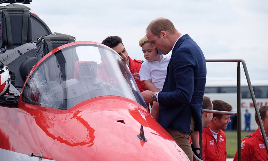 prince william looking at helicopter