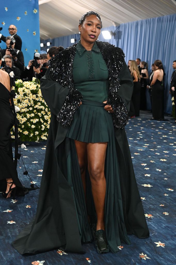 Venus Williams wears a green mini dress with pleated skirt and long jacket with embellished details on the labels and cuffs.